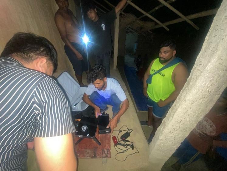 Ministry team setting up broadcast and film equipment at night